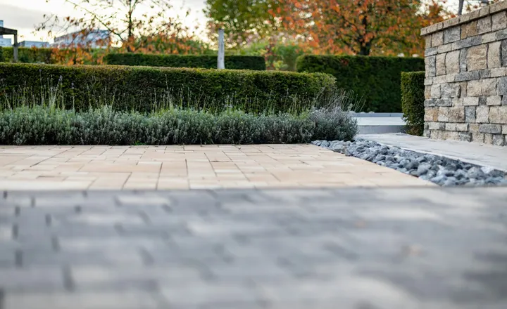 Stone paving and clipped hedges in a landscaped garden